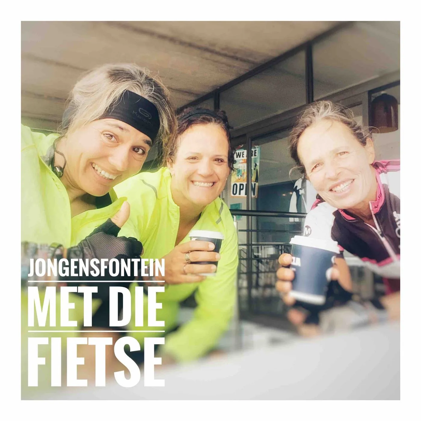 Three women in cycling gear take a selfie and raise paper cups, captioned Jongensfontein, met die fietse.