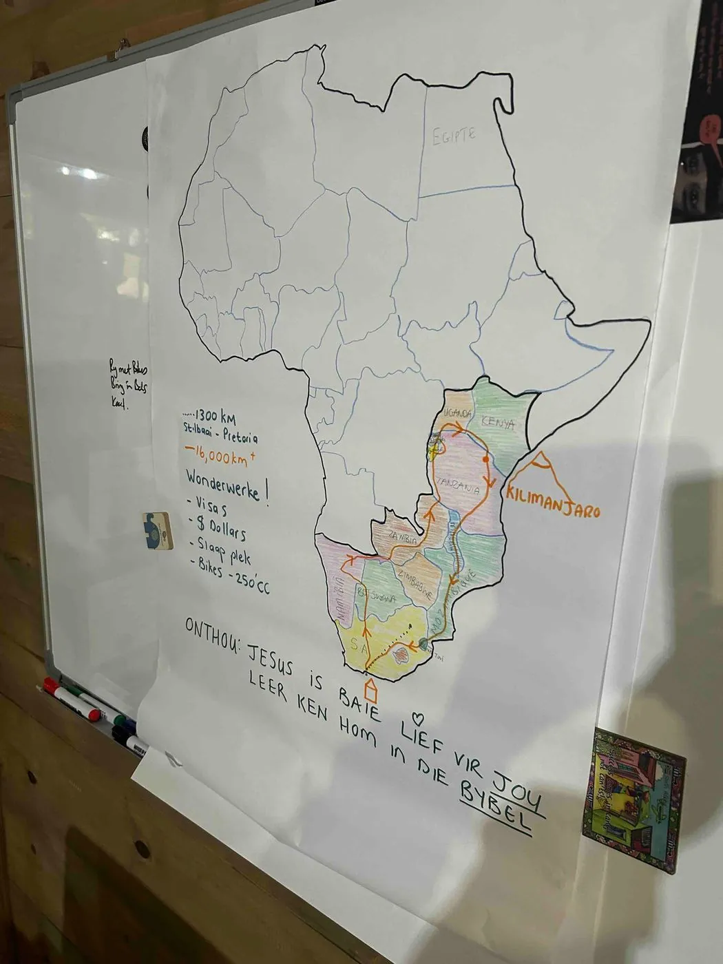 A whiteboard with a hand-drawn map of Africa, some countries coloured in, and notes written underneath.