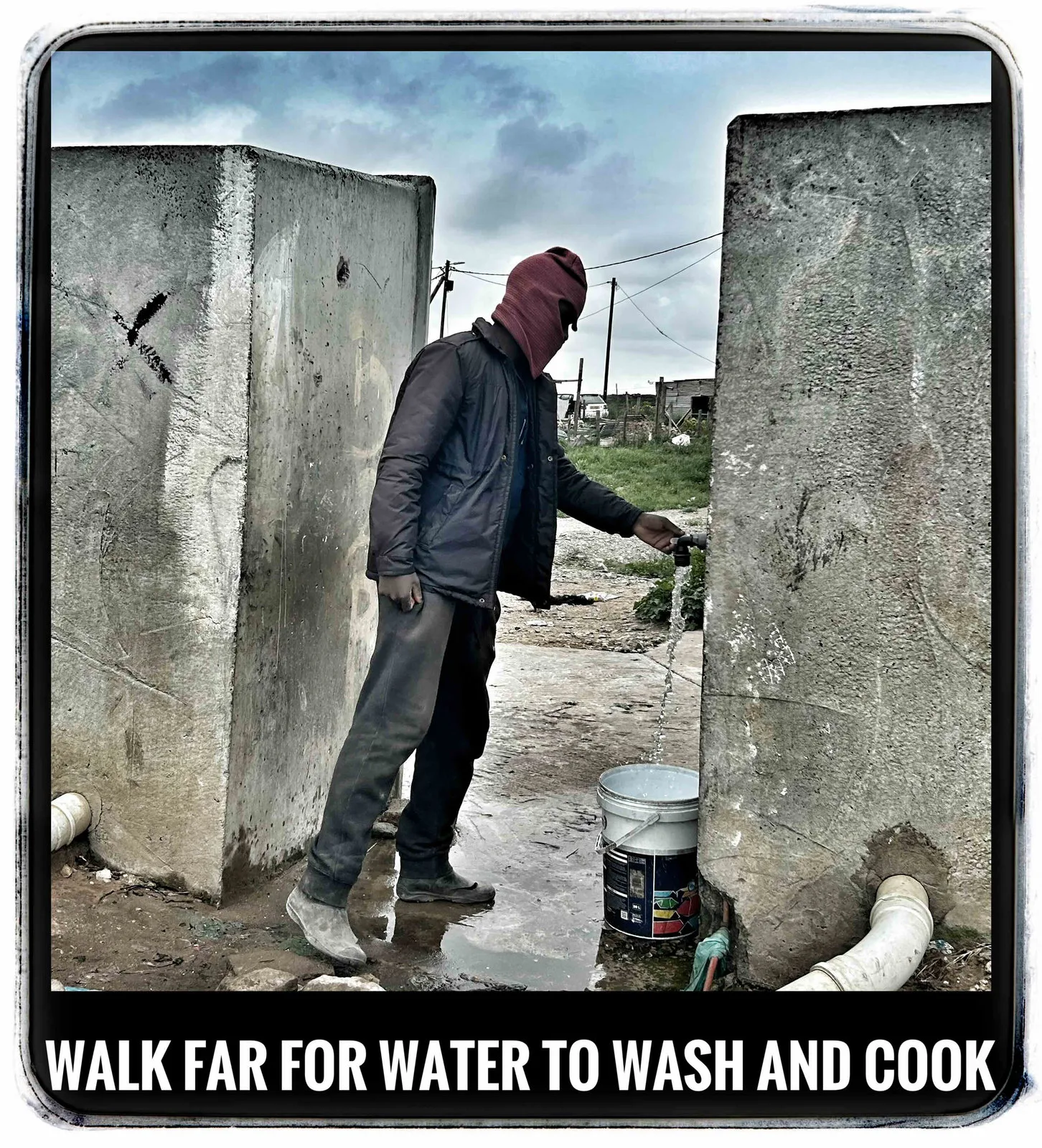 A man in a hooded jacket and mask fills a bucket at an outdoor tap between two concrete walls, captioned Walk far for water to wash and cook.